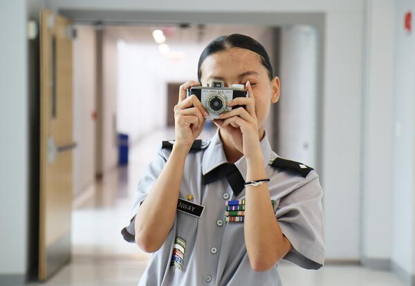 Albany High student posing with a camera