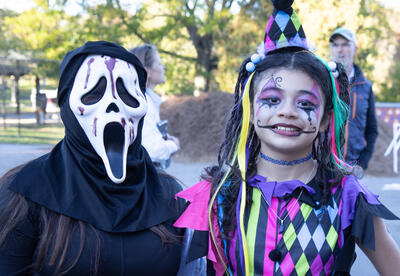 Two students in costume: one dressed as the character from the Munch painting "The Scream," the other as a harlequin
