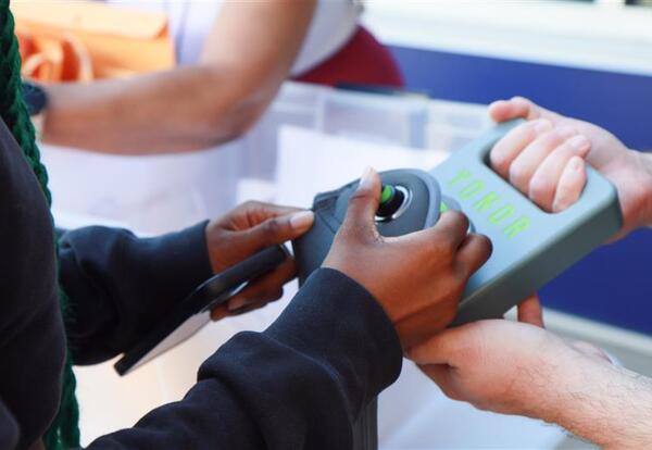 Student unlocking a Yondr pouch