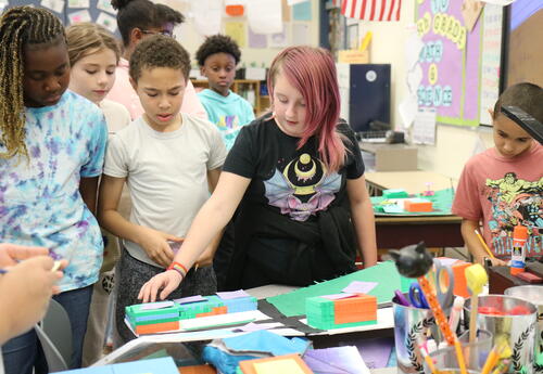 A students shares highlights from a STEM project with classmates.