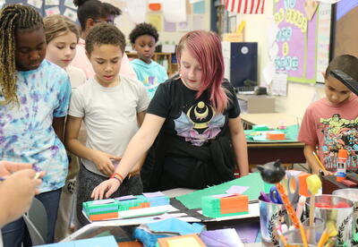 A students shares highlights from a STEM project with classmates.