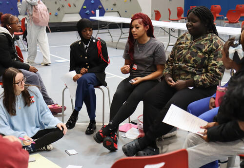 Peer group leaders discussing ground rules with their outreach group