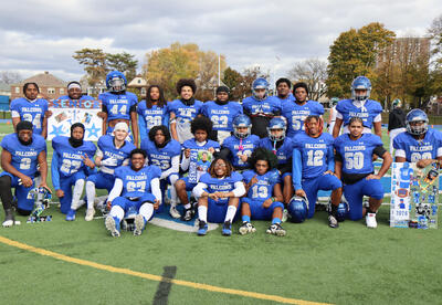 Seniors on football team posing together on the field