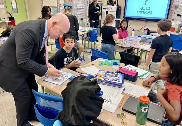 District Attorney Lee Kindlon works with students at Pine Hills Elementary School.