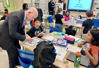 District Attorney Lee Kindlon works with students at Pine Hills Elementary School.