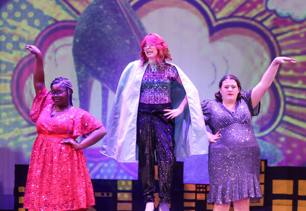 Theater Ensemble performers dressed as superheroes