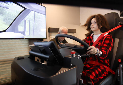Student seated and driving in the CDL simulator