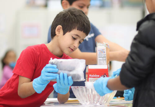 Students measuring ingredients to make trail mix