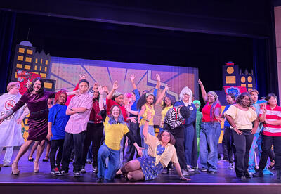 Image of the actors posing on stage together at the end of one of the scenes