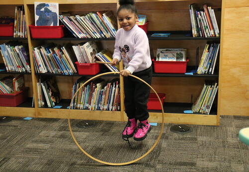 A student plays with a hula hoop.
