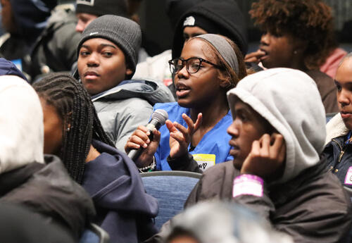 Student with microphone sharing during the assembly