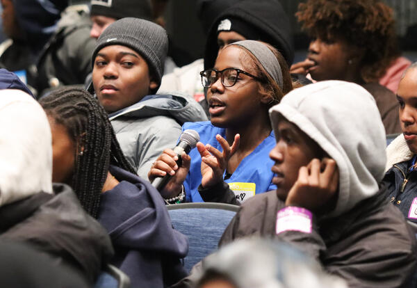 Student with microphone sharing during the assembly