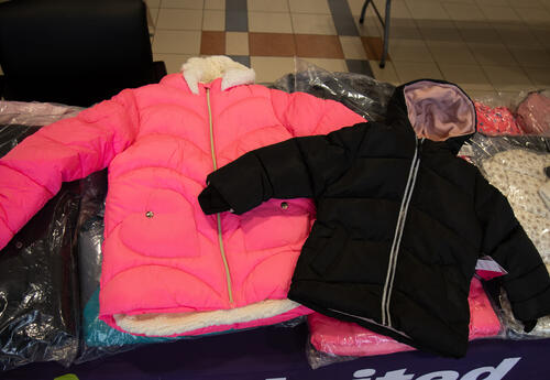 New pink and black coats displayed on a table