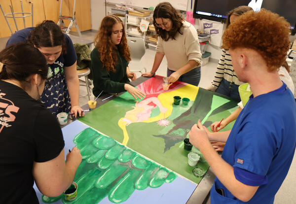 Photo of students working on the artwork at Albany High
