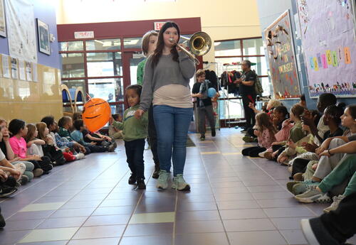 Students lead a pre-Thanksgiving parade through the school
