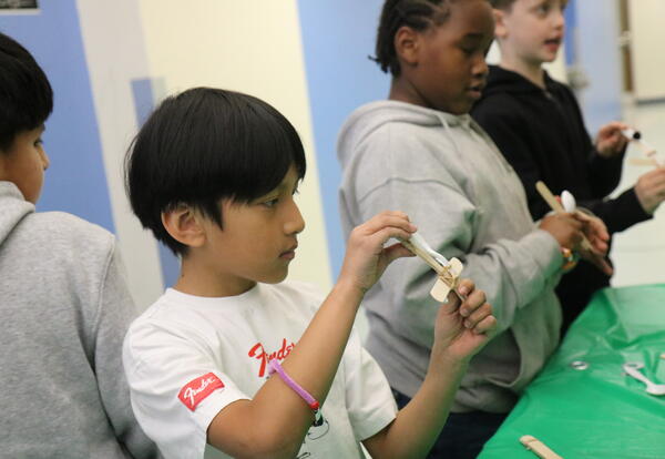 A students tests a home made catapult.