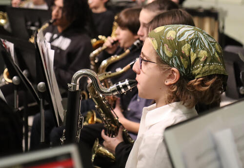Student plays bass clarinet during the performance