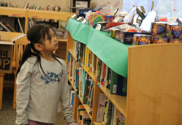 A student shops at the school's Holiday Bazaar.
