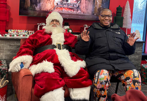 A student from Best Buddies saying "hi" to Santa at Quick Response