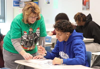 Colleen Multer working with a student during the class