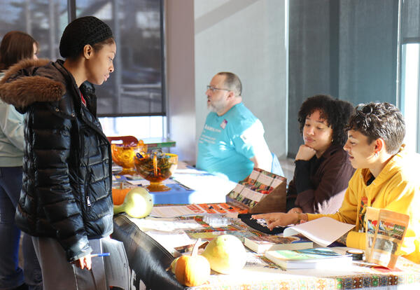 Group of students speaking to a community leader