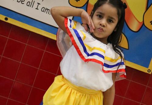 A student poses in traditional holiday dress.