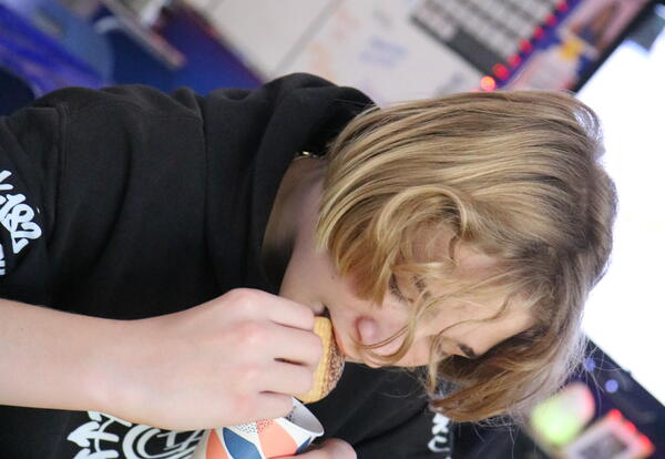 A student samples Mexican hot chocolate.