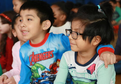 Two pajama-clad boys enthusiastically sing