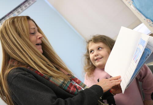 A student shares her ELA journal with an educator.