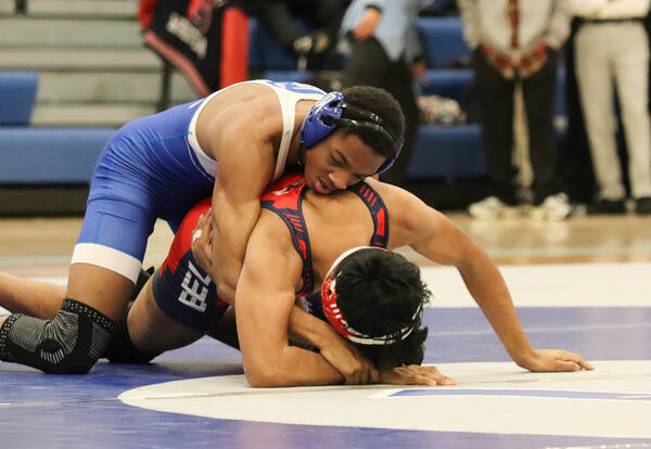 Albany High student wrestling an opponent at the match