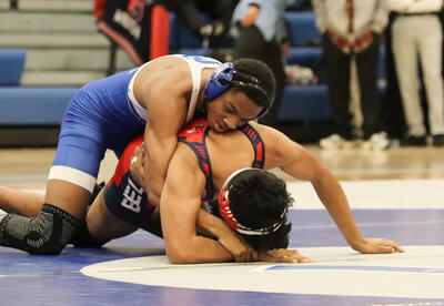 Albany High student wrestling an opponent at the match
