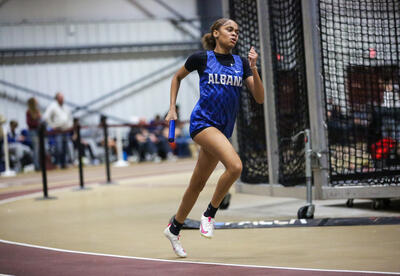 Maliyah Williams from the girls' team running a relay