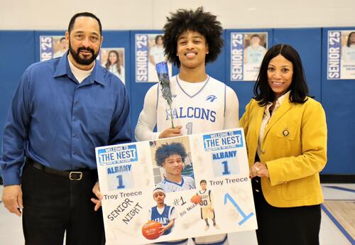 Photo of senior from boys' basketball team last year with loved ones