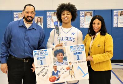 Photo of senior from boys' basketball team last year with loved ones