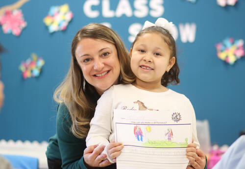 Tara Bosiak posing for a photo with a student