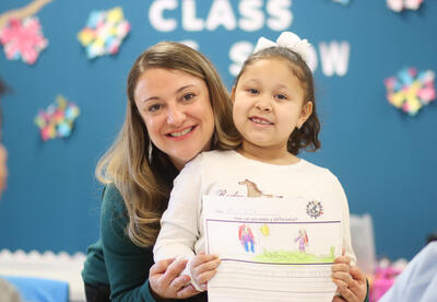 Tara Bosiak posing for a photo with a student