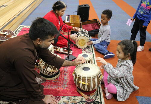 Students learn to play instruments used by musicians in India.
