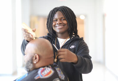 Barbering student cutting hair
