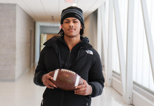 Photo of Levi holding a football