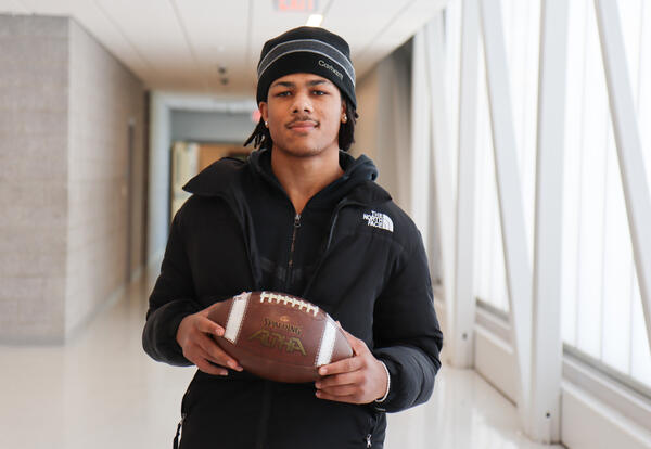 Photo of Levi holding a football