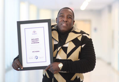 Decky Lawson holding up his award