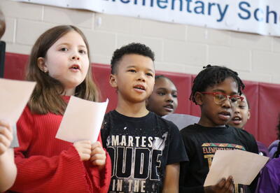 Students sing during a Black History Month assembly.