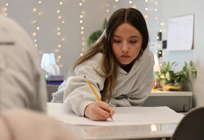 Student working on a poster during the group project