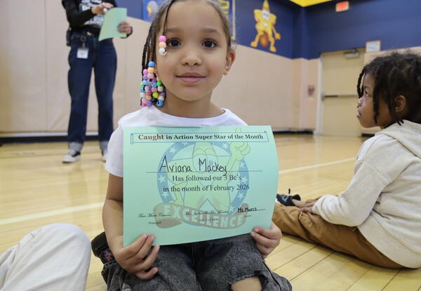 Student holding certificate