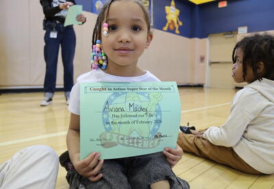 Student holding certificate