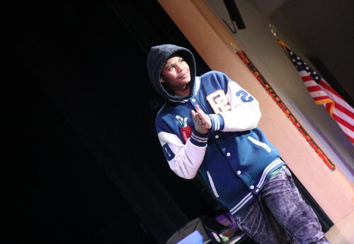 A student walks across the state at the honor roll ceremony.