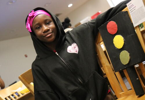 A student displays her Black History Month project.