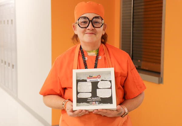 Lisa Valentine holding the Top Teacher Award from WNYT/Ch. 13