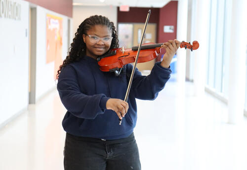 Harvey holding her violin