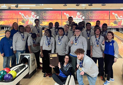 Unified bowling team with championship plaque